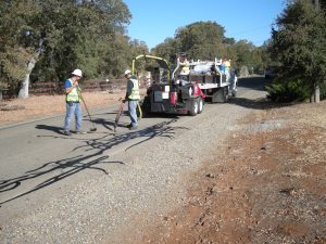 men and equipment working on road